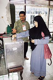An Indonesian citizen casting her vote in a presidential election